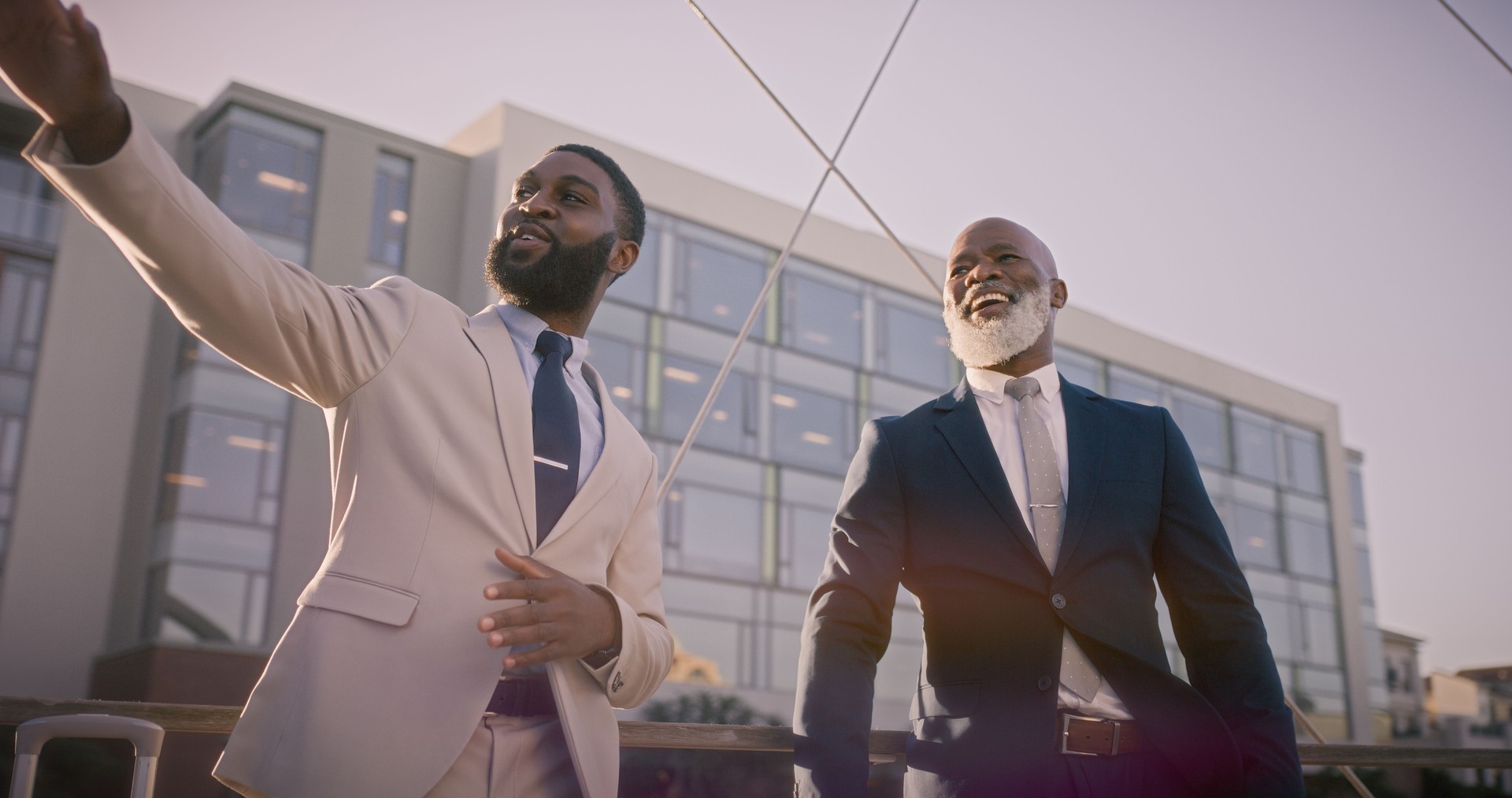 Business men, conversation and city with morning, commute and travel with a urban building and smile. Job, entrepreneur and career talk with a African male professional and corporate ceo in town