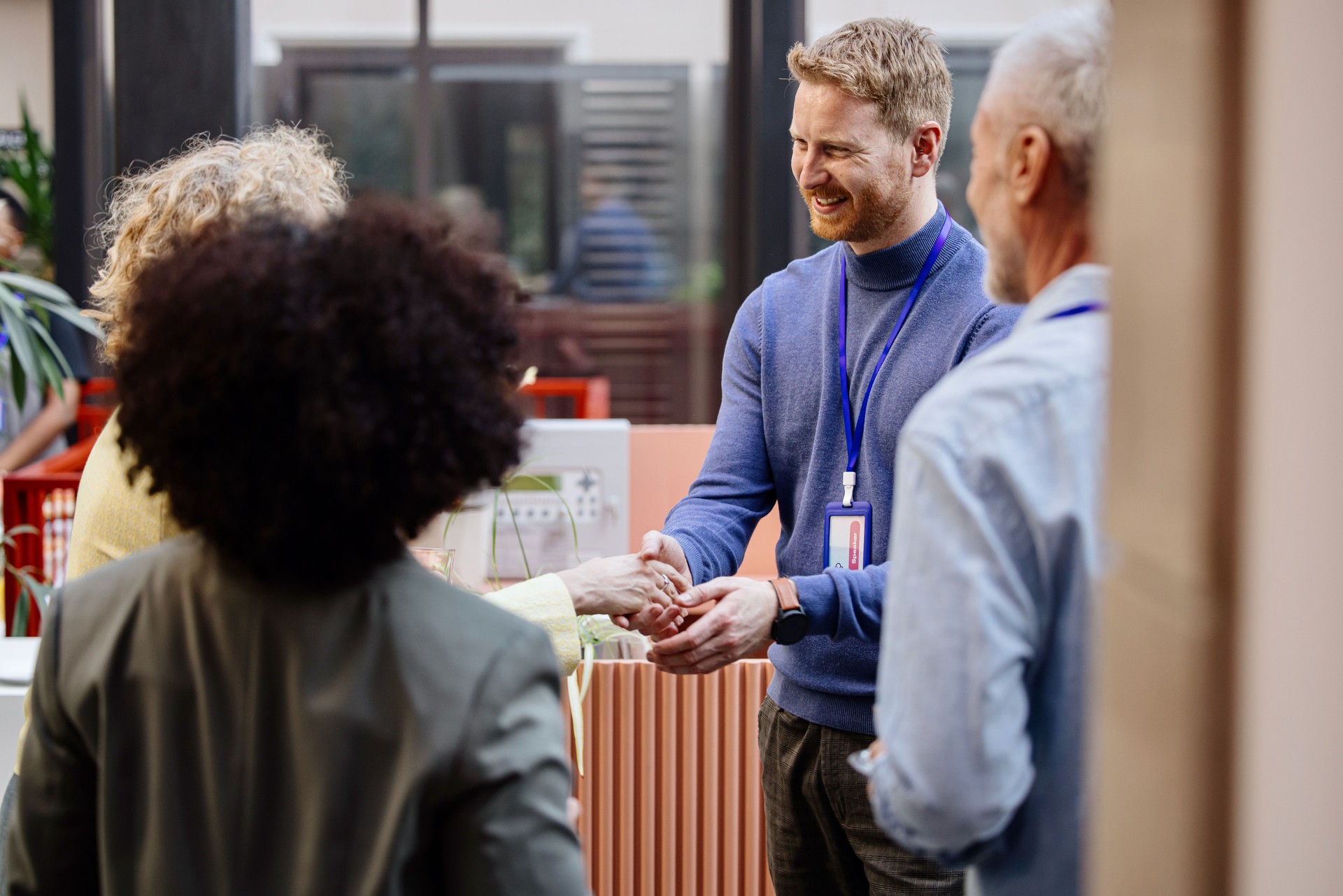 Business people greet each other during a coffee break at a conference